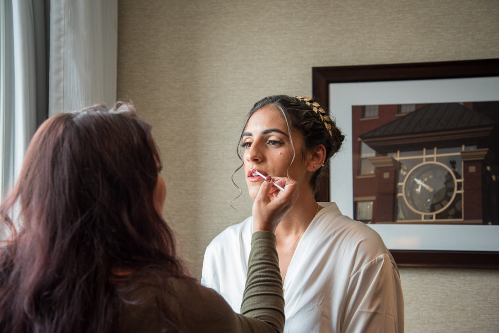 bride getting her lipstick applied , shot by NH wedding Photographer