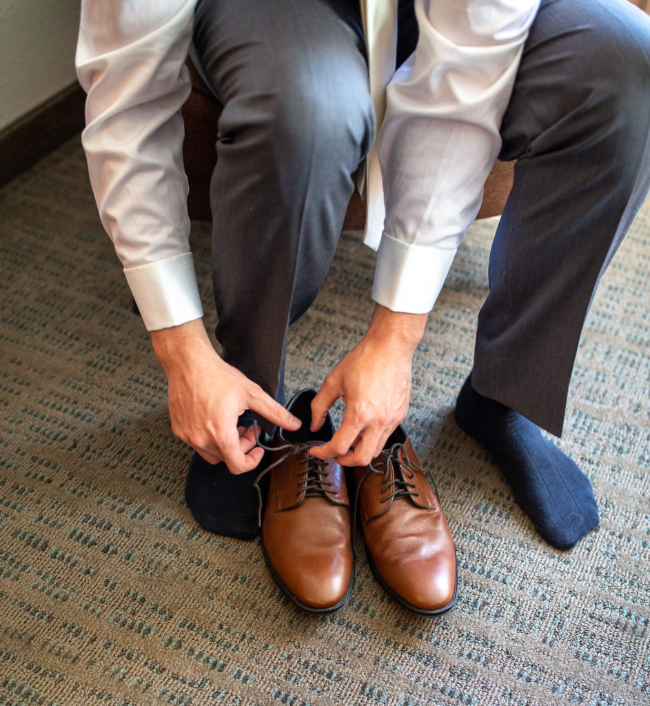groom putting his shoes on