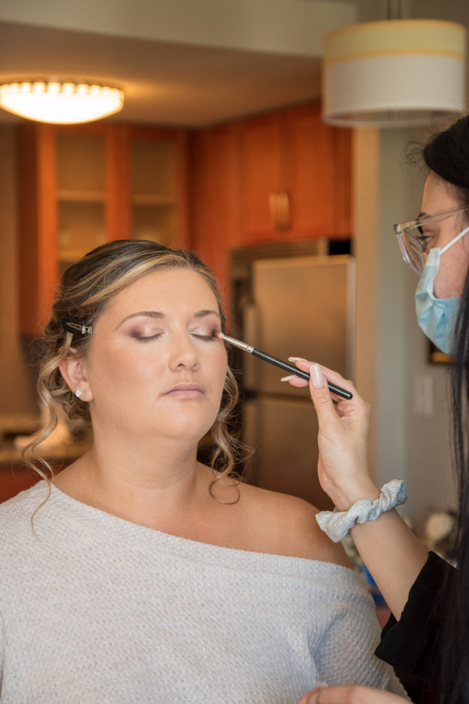 bride getting her make up done for the perfect fall wedding