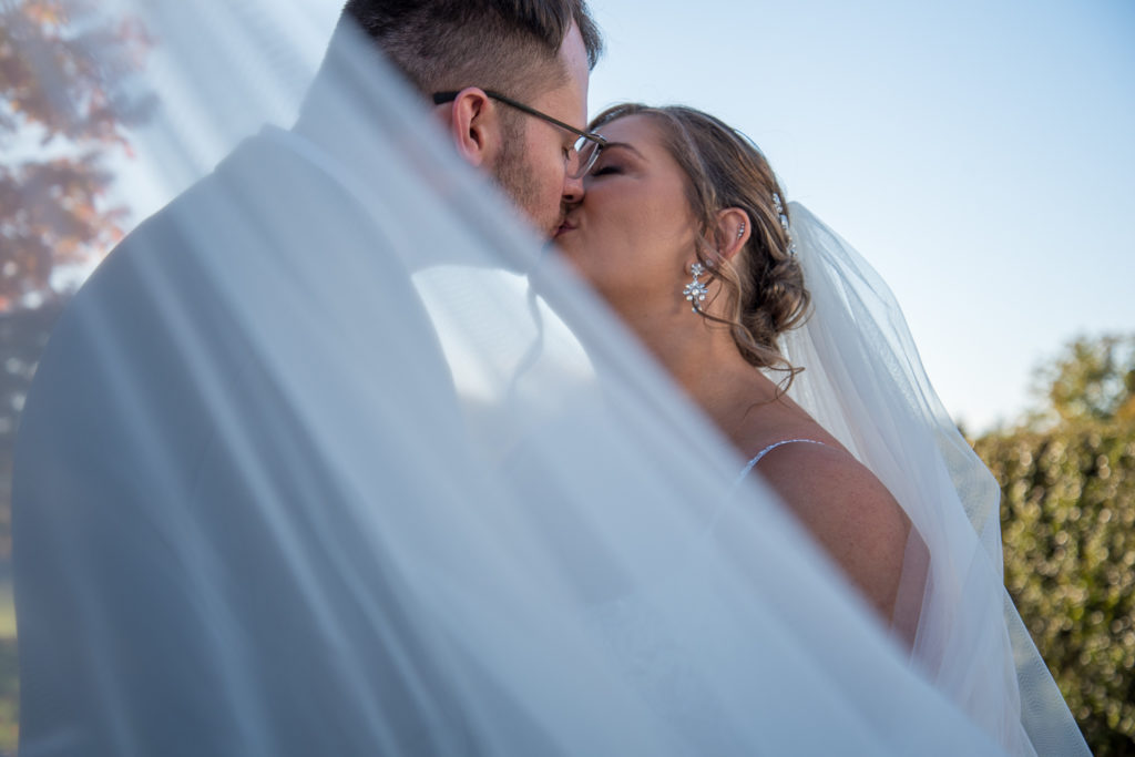 bride and groom kissing under the veil