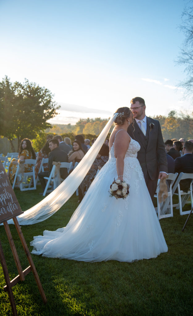 walking down the aisle as husband and wife at the perfect fall wedding