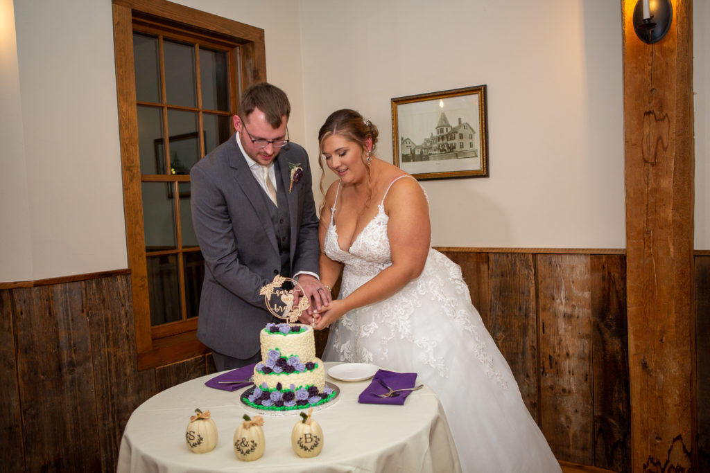 bride and groom cutting the cake at the perfect fall wedding