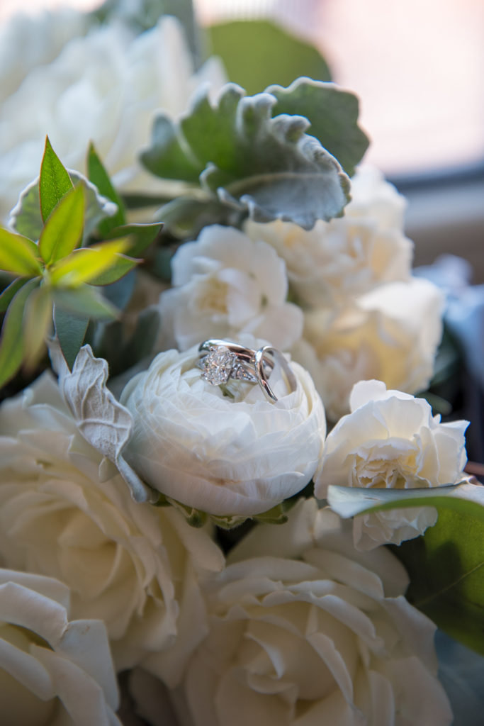 wedding ring shot on bridal bouquet at winter oceanside wedding 