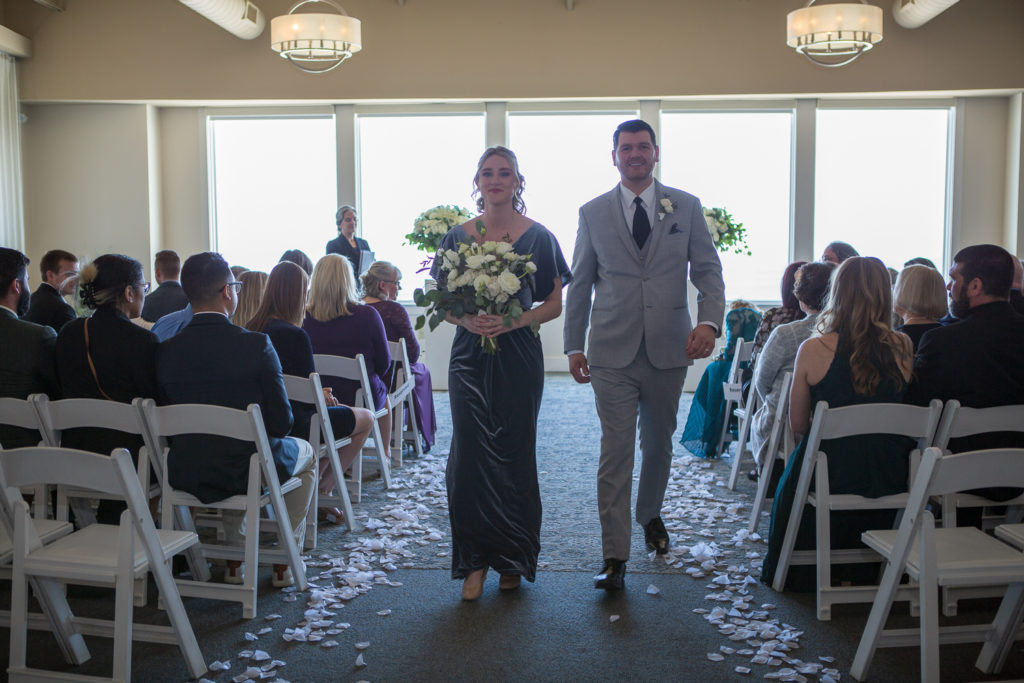 bridal party leaving the ceremony at winter oceanside wedding