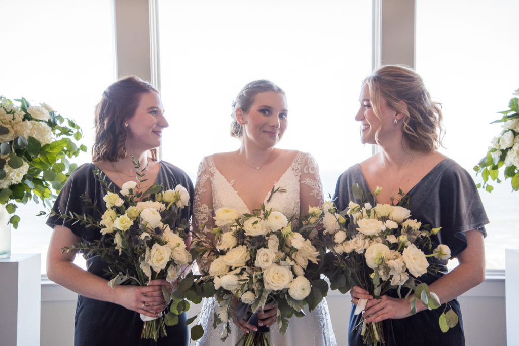 bridesmaids looking at bride smiling 