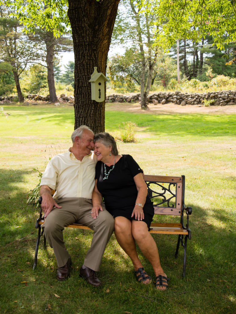 Sixty Years of marriage couple sitting on a bench looking at each other