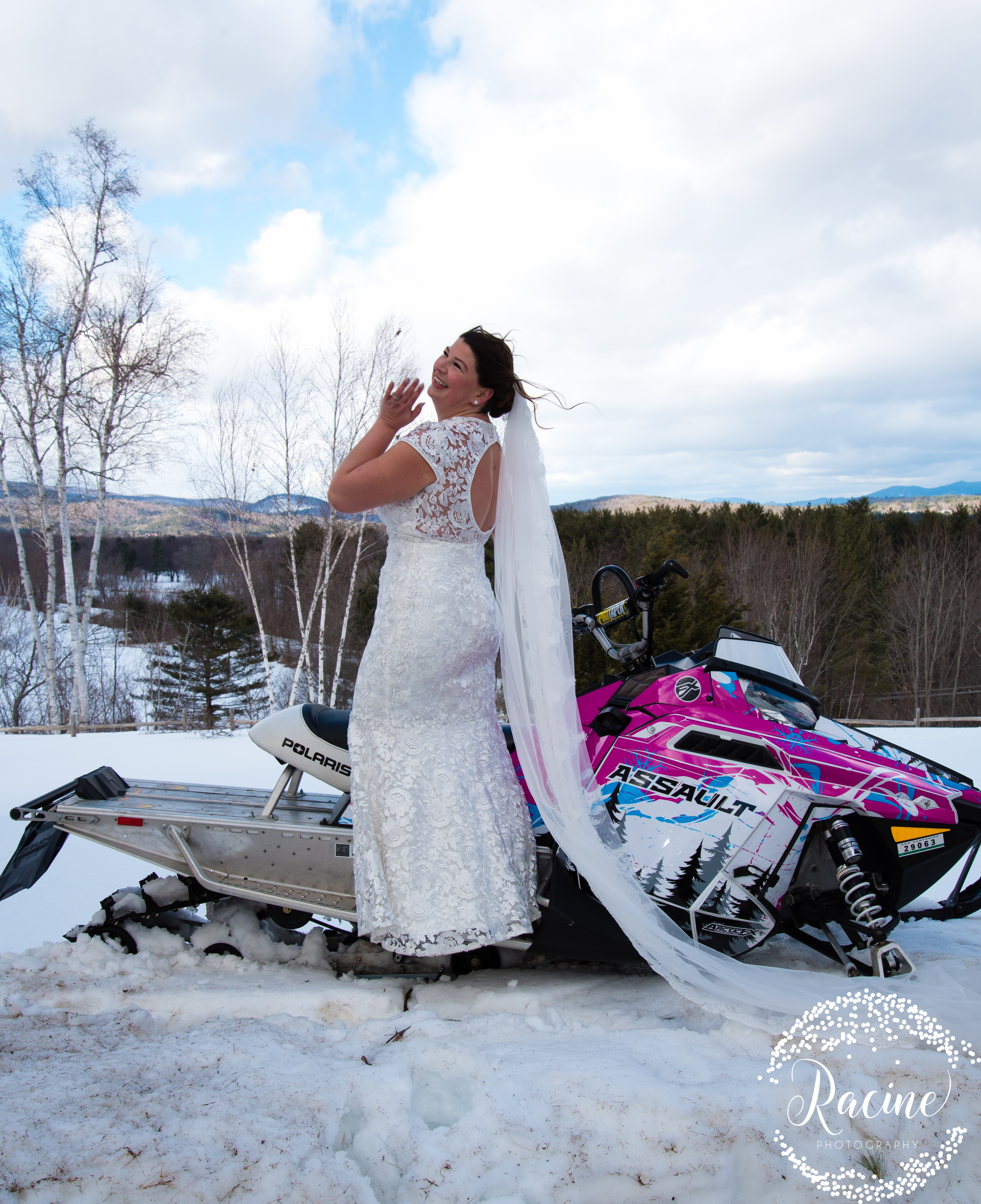 bride and groom on snowmobiles
