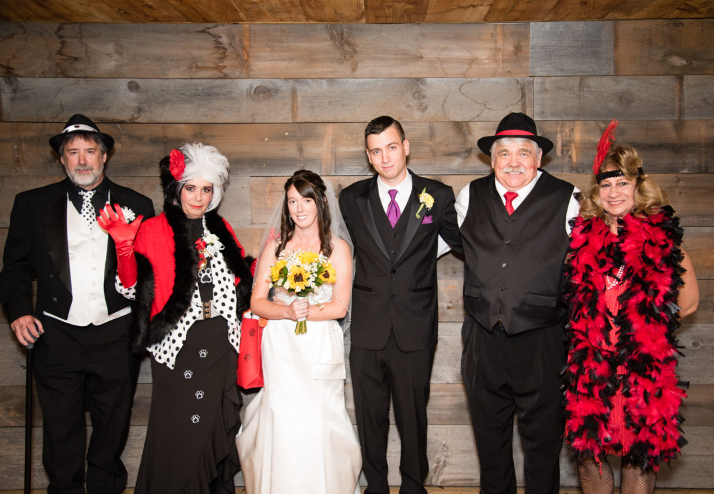 bride and groom with their parents who are dressed up for Halloween