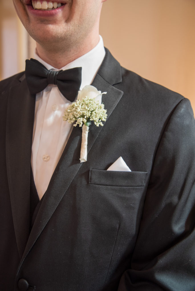 close up of groom and boutonniere 