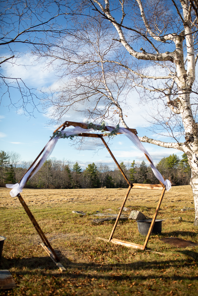 hexagon shaped arbor for ceremony with tulle on it in between white birch trees at Whitney Farm Estate