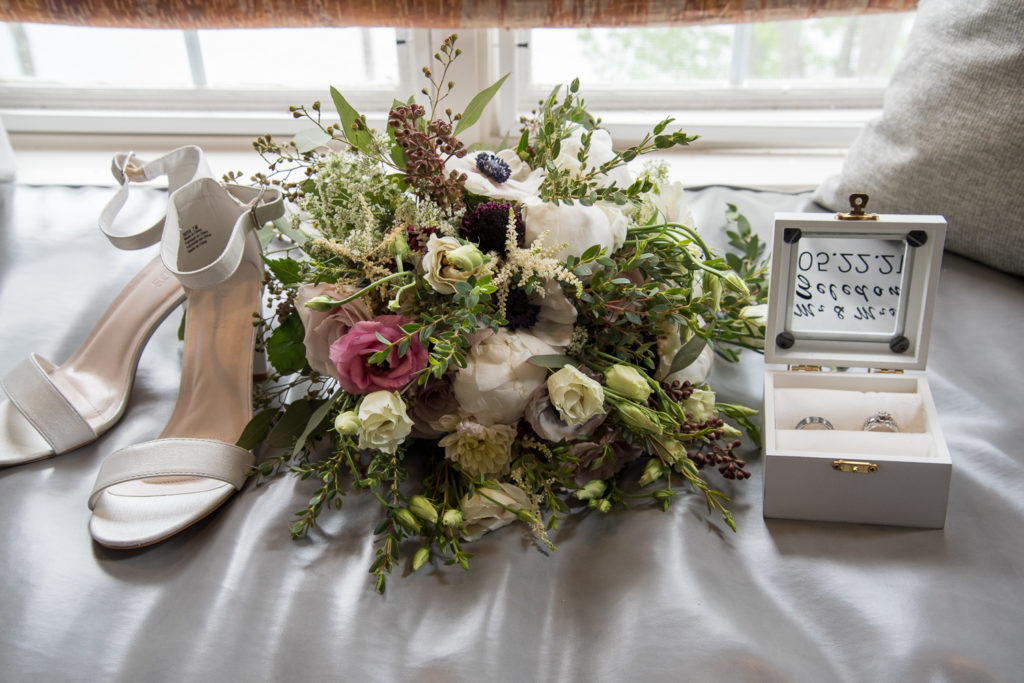 bridal bouquet with wedding shoes and rings
