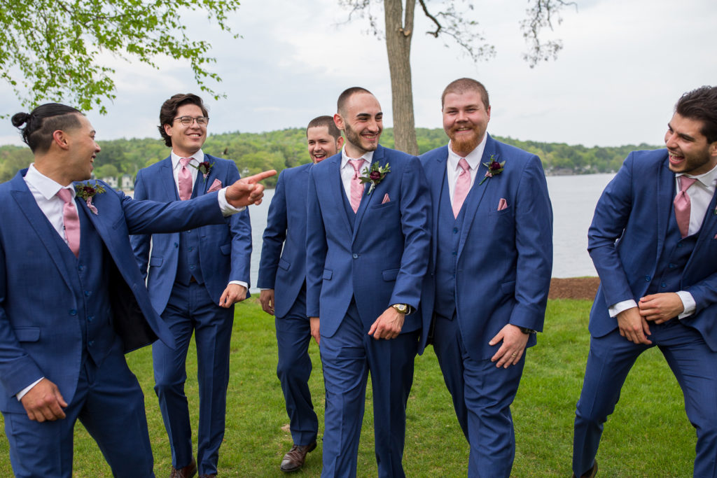 groom and his guys walking towards the camera smiling
