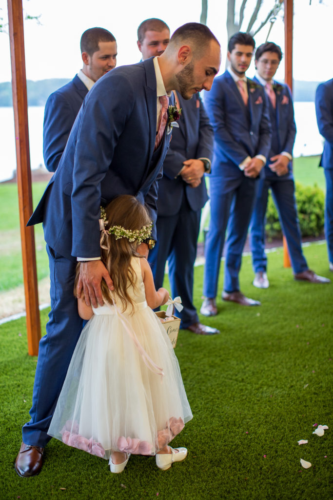 daughter of bride and groom, hugging her daddy at the end of the aisle