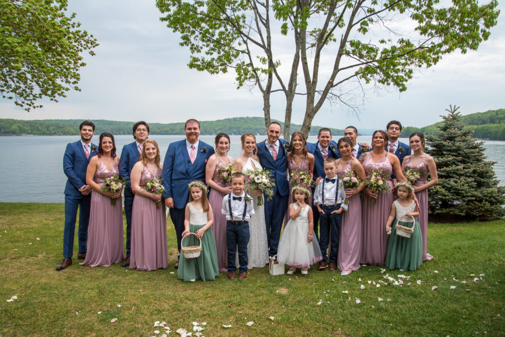 bridal party posing in front of the lake