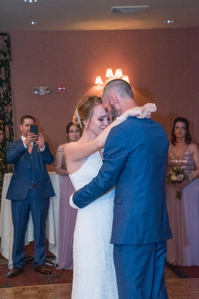 bride and her dad, forehead to forehead while dancing 