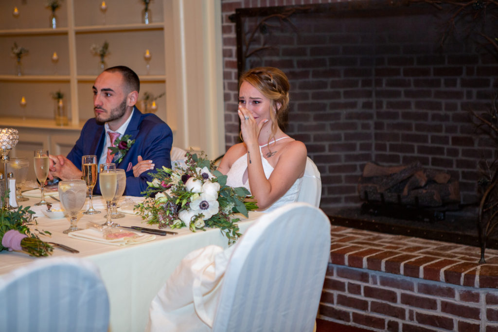 bride crying as she listens to the wedding speeches 