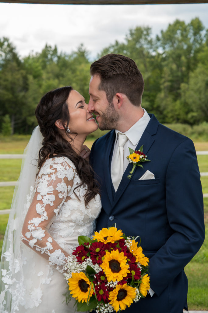 bride and groom nuzzling noses at fall wedding at the barn 