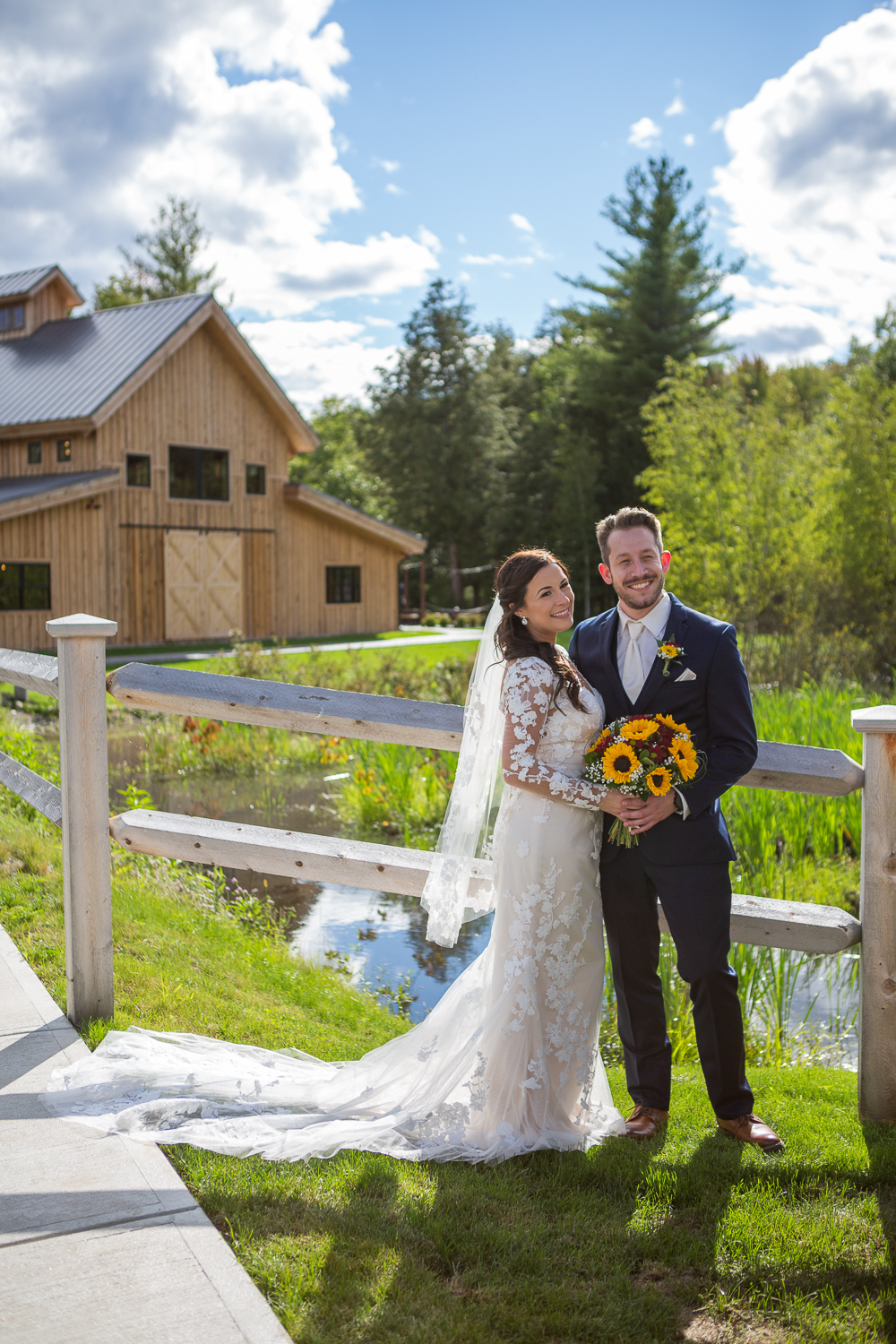 bride and groom posing in front of the barn at bull meadow