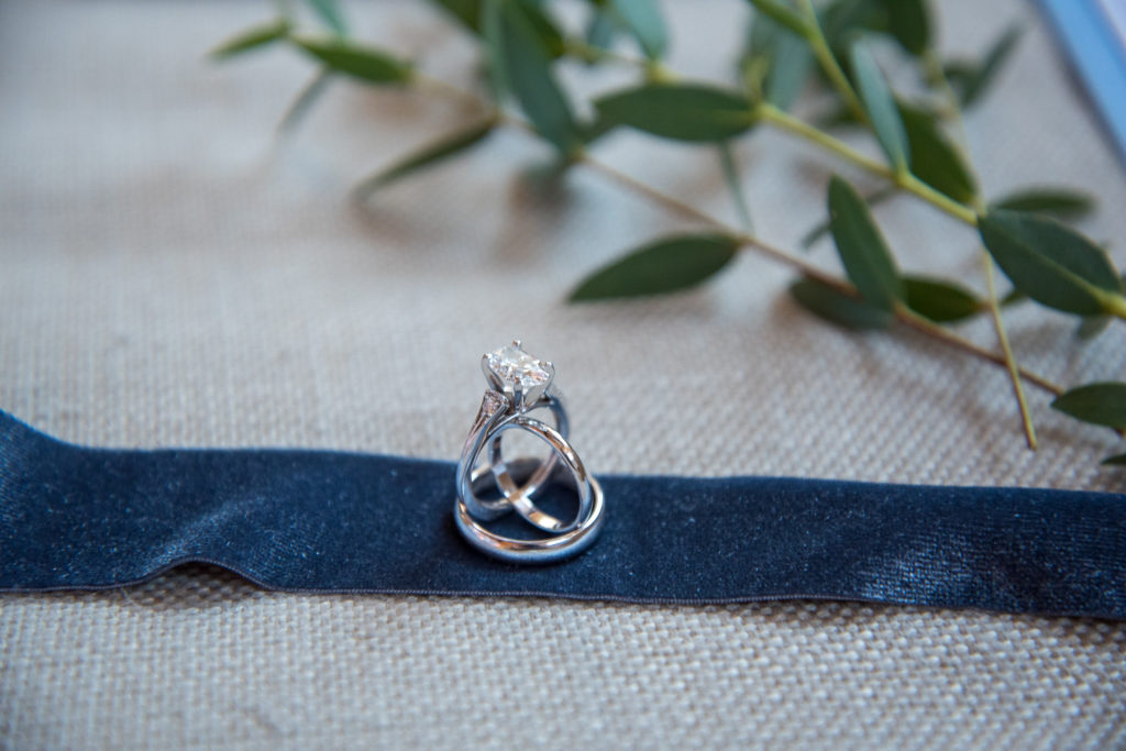 wedding rings set up on navy blue ribbon for Winter Oceanside wedding