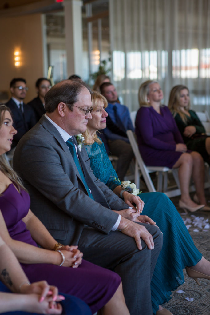 grooms parents watching the ceremony with tears in their eyes 