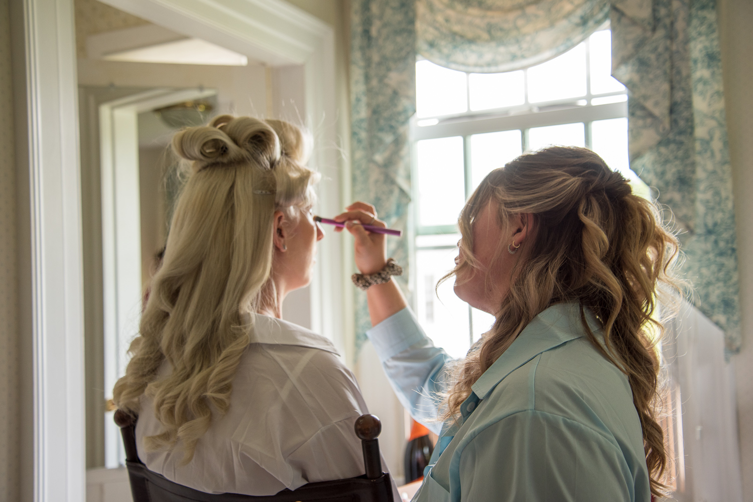 bride getting her make up done on the perfect day