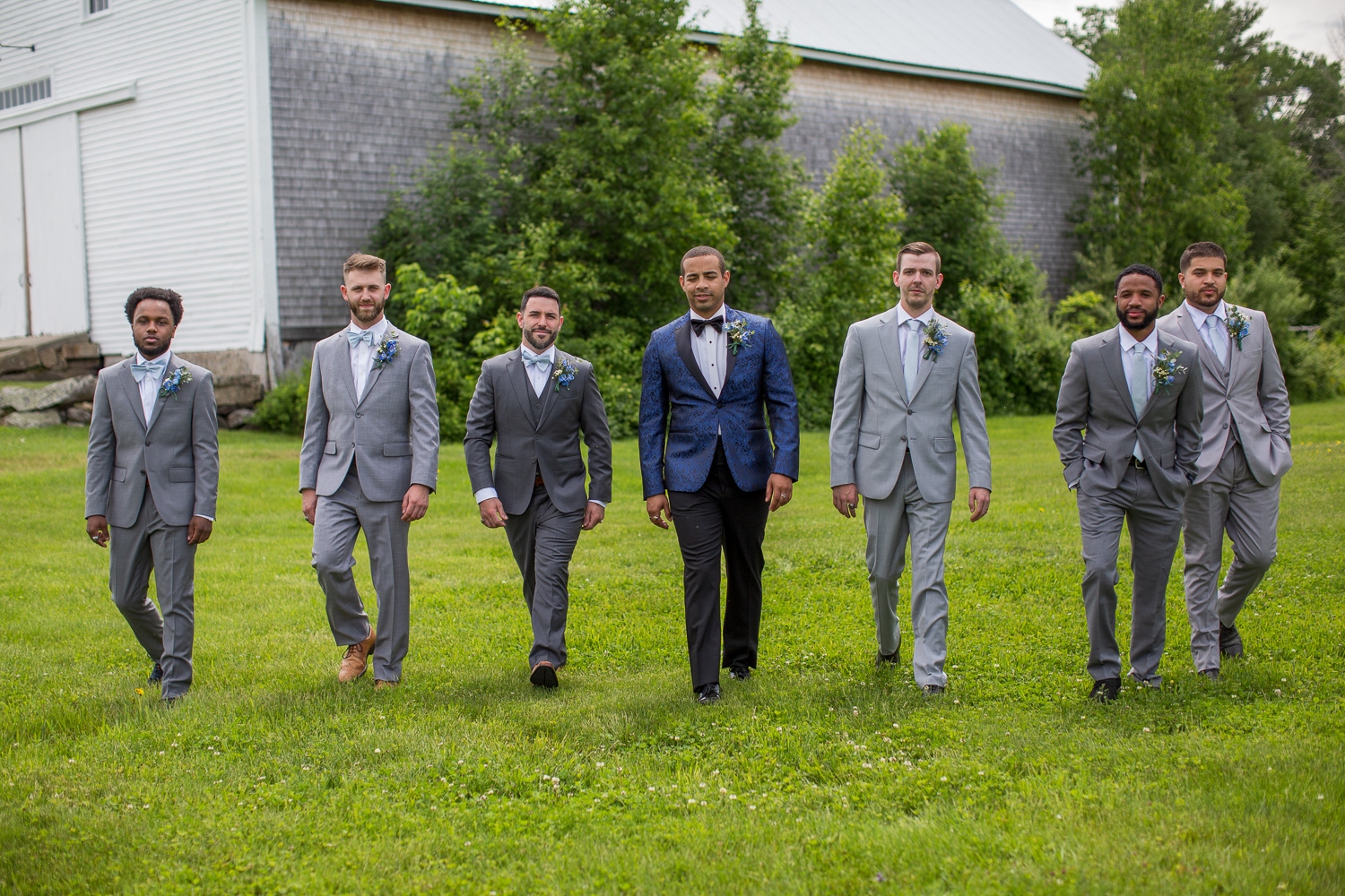 groom with his groomsmen in front of the Whitney Farm Estate barn at the perfect day