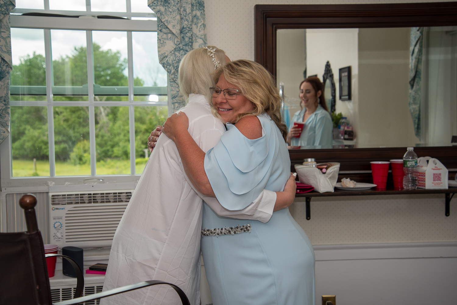mother of the bride hugging bride on the perfect day
