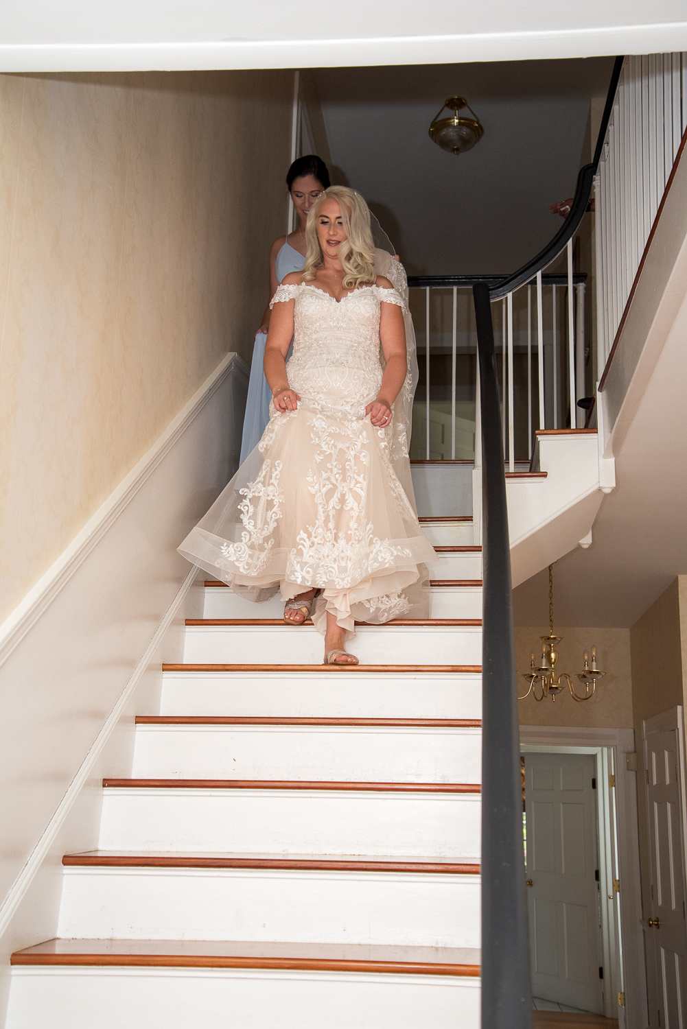 bride walking down stairs of country home on the perfect day 