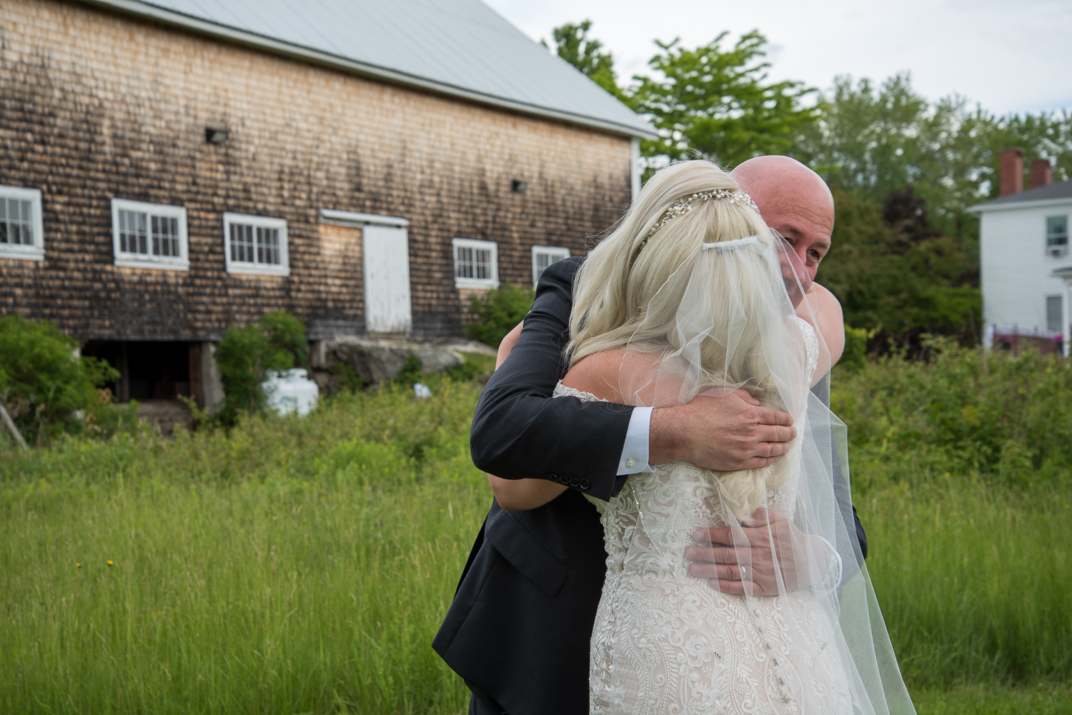 dad hugging bride after seeing her for the first time at whitney farm estate