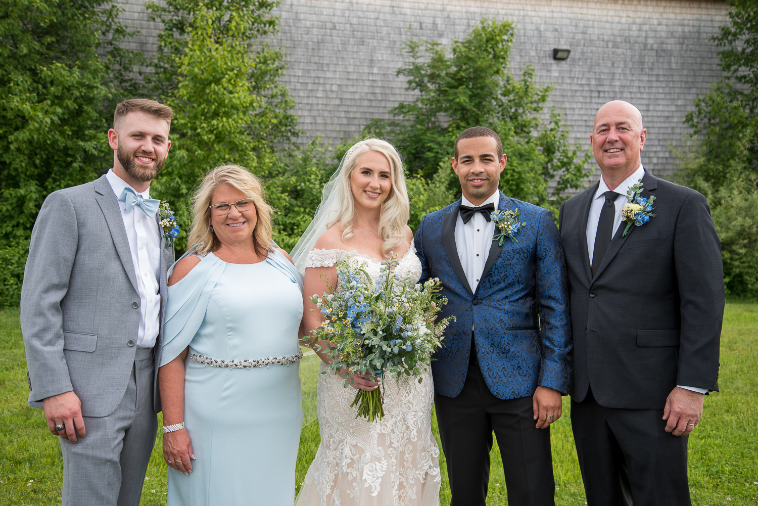 bride's family with bride and groom in front of the barn at the perfect day