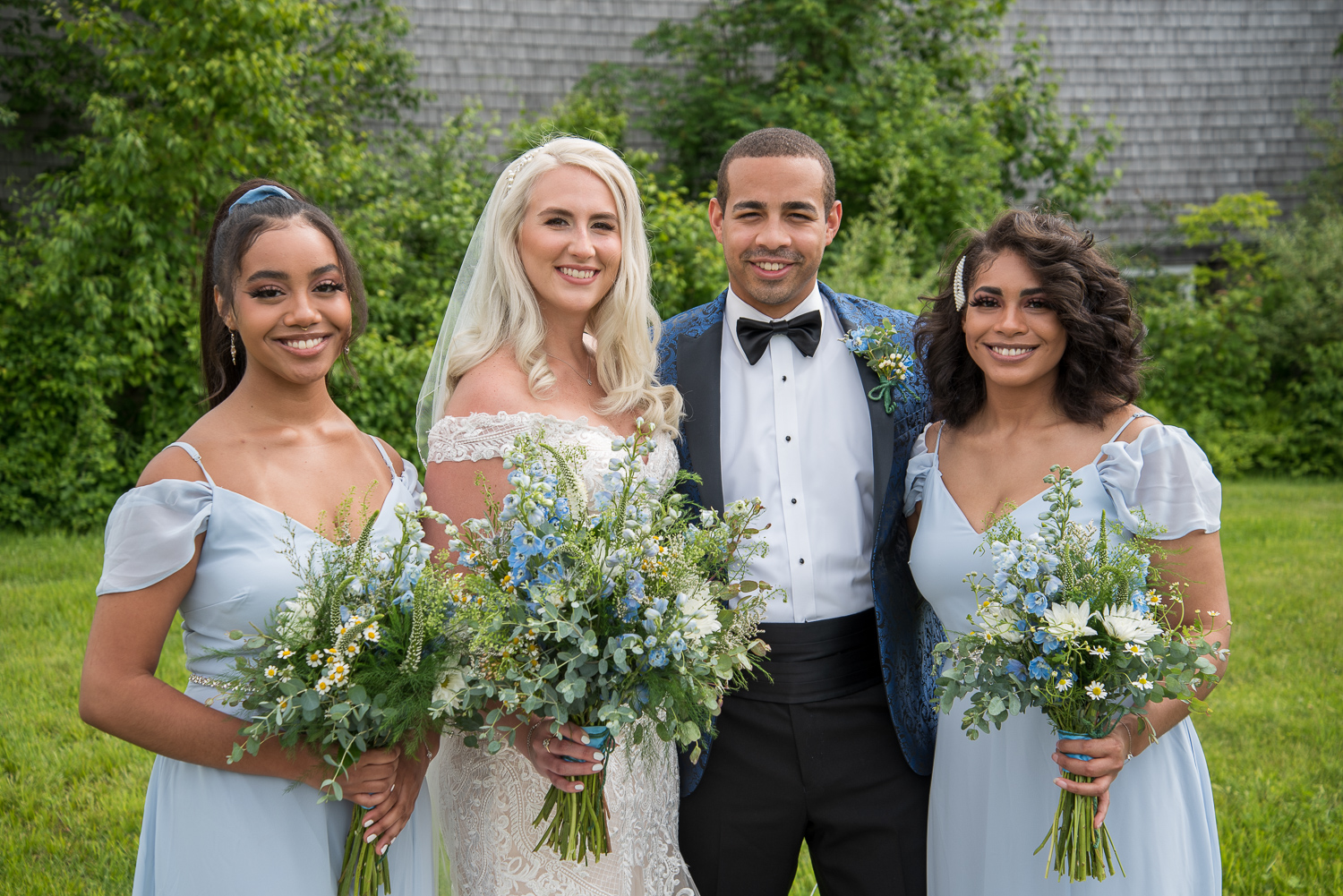 bride and groom with his sisters at the perfect day