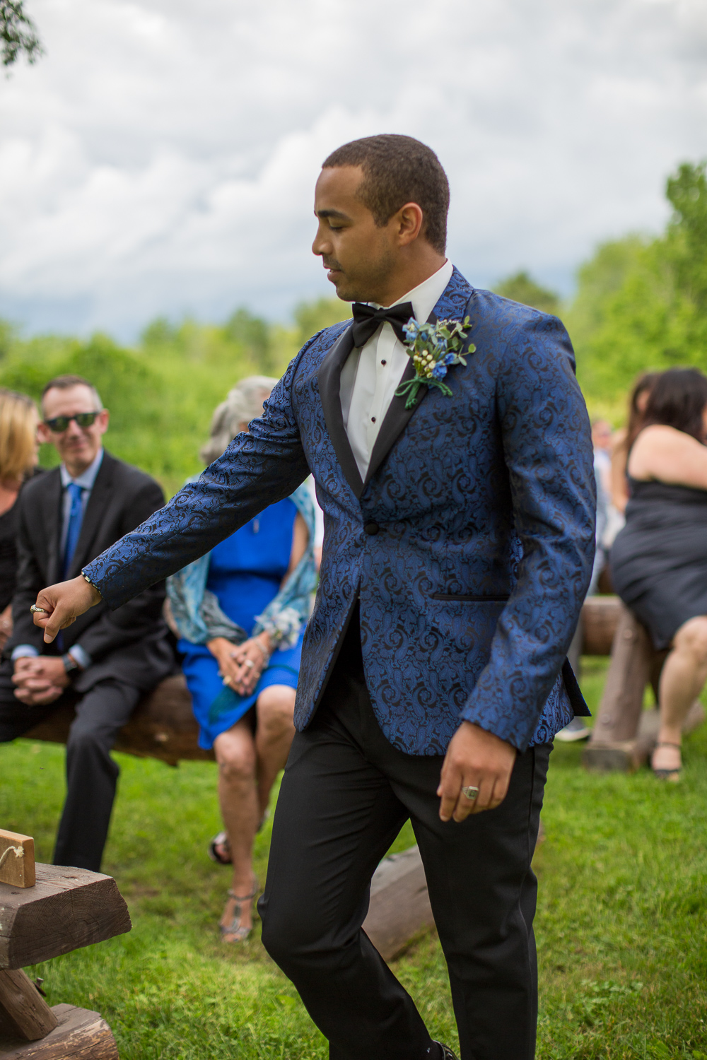 groom fist pumping guest as he walks down the aisle to the ceremony at the perfect day