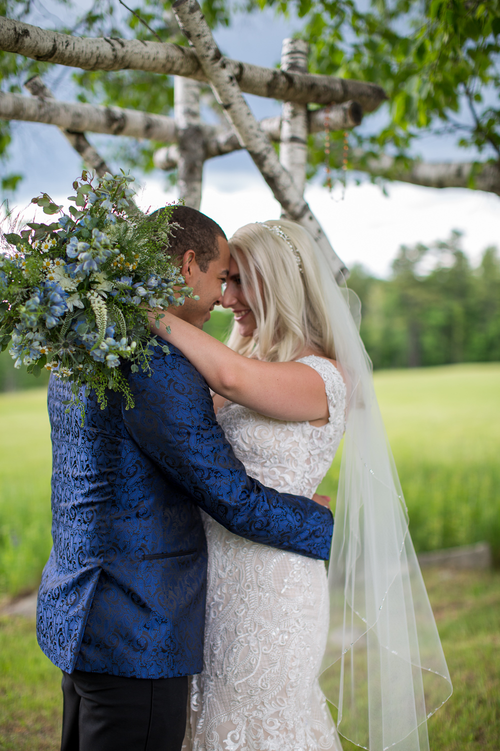 bride and groom in front of their white birch tree alter at the perfect day