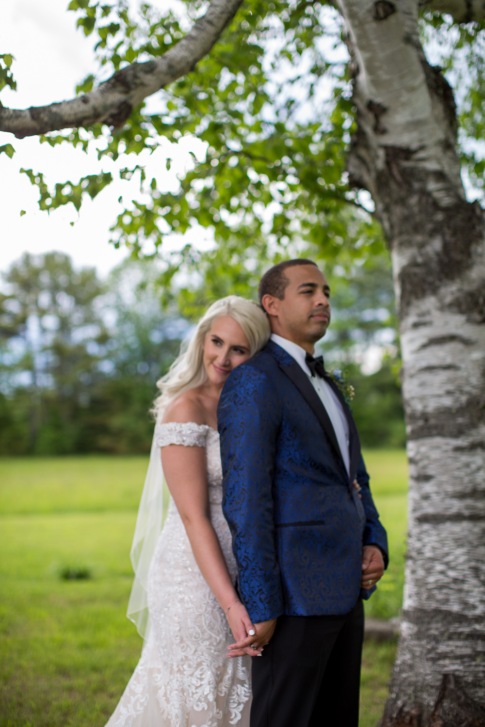 bride and groom leaning against a white birch tree at the perfect day