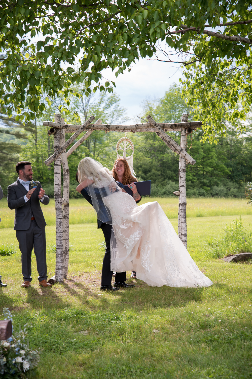 groom lifts bride up at the first kiss during the perfect day