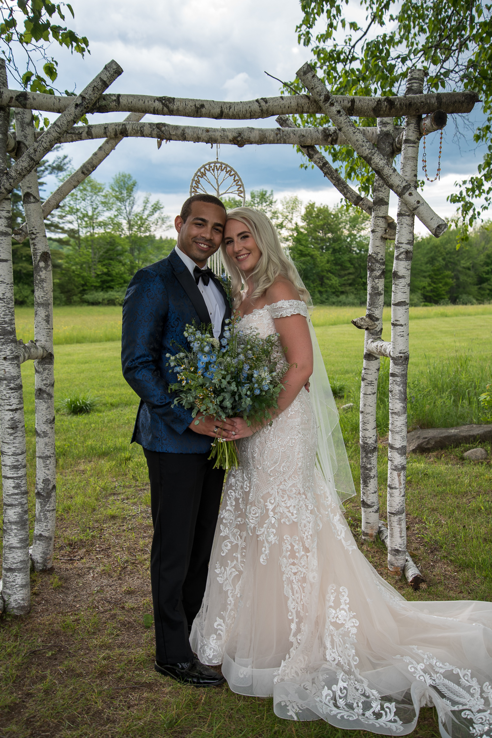 bride and groom in front of their white birch tree alter at the perfect day
