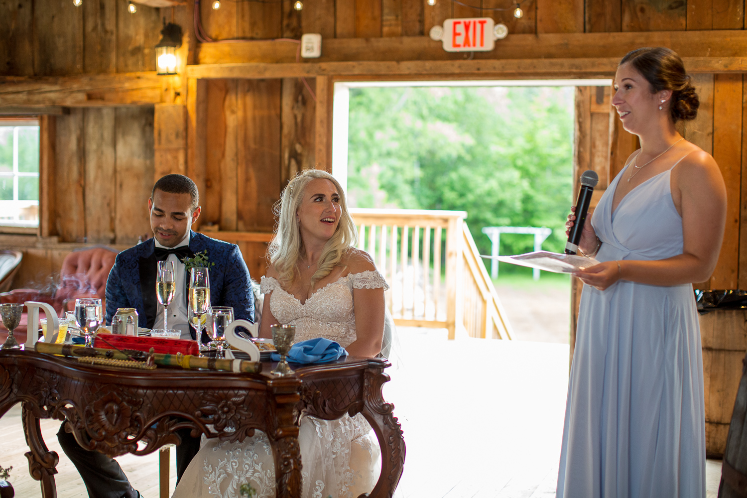 maid of honor giving her speech to bride and groom at the sweetheart table at the perfect day