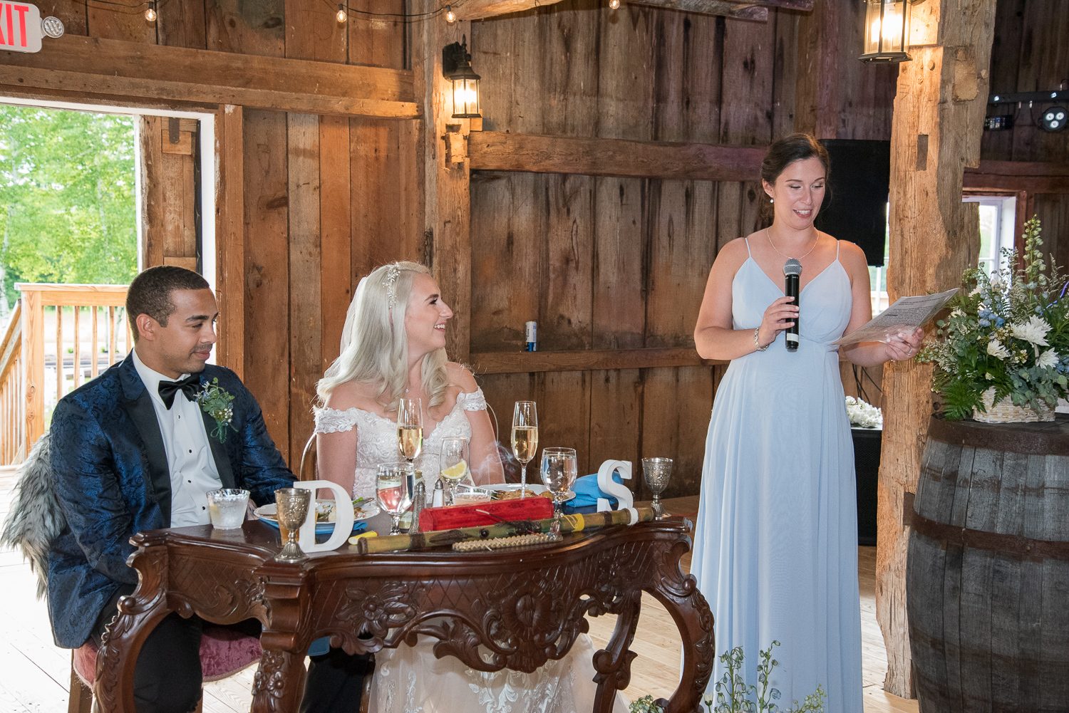 maid of honor giving her speech to bride and groom at the sweetheart table at the perfect day