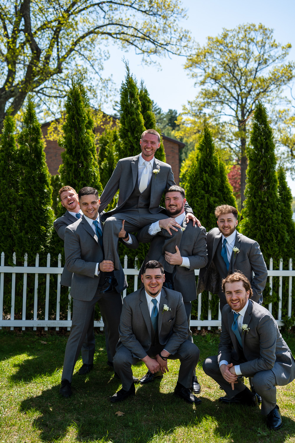 Groomsmen holding the groom up 