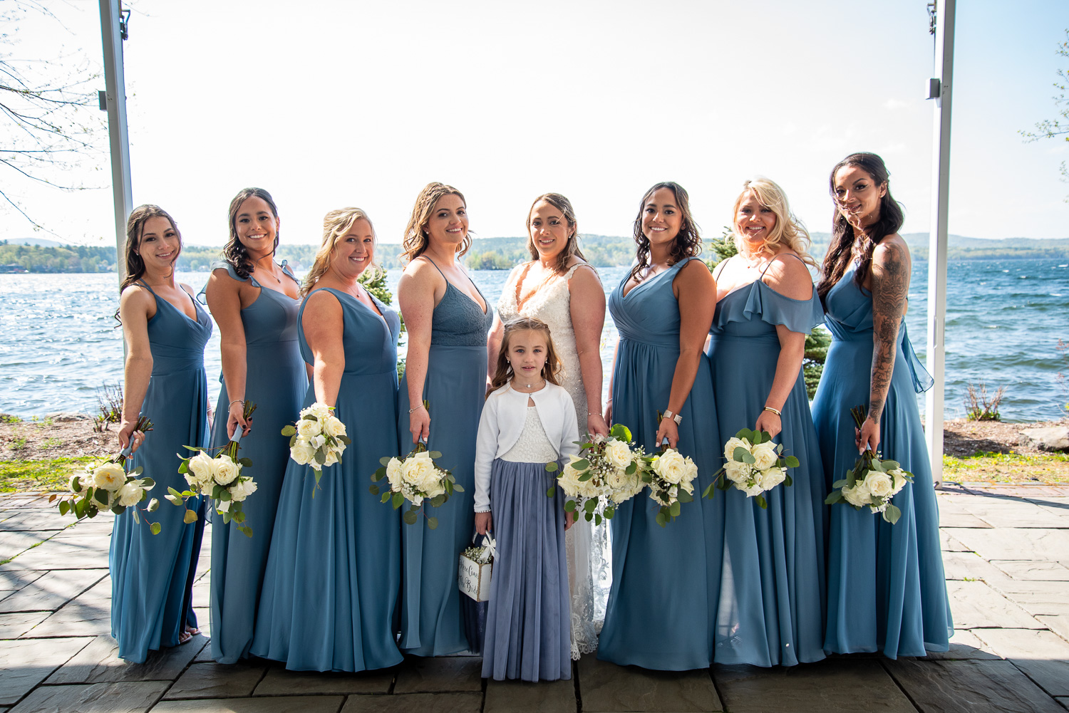 Bride, bridesmaids and flower girl after the lakeside wedding 