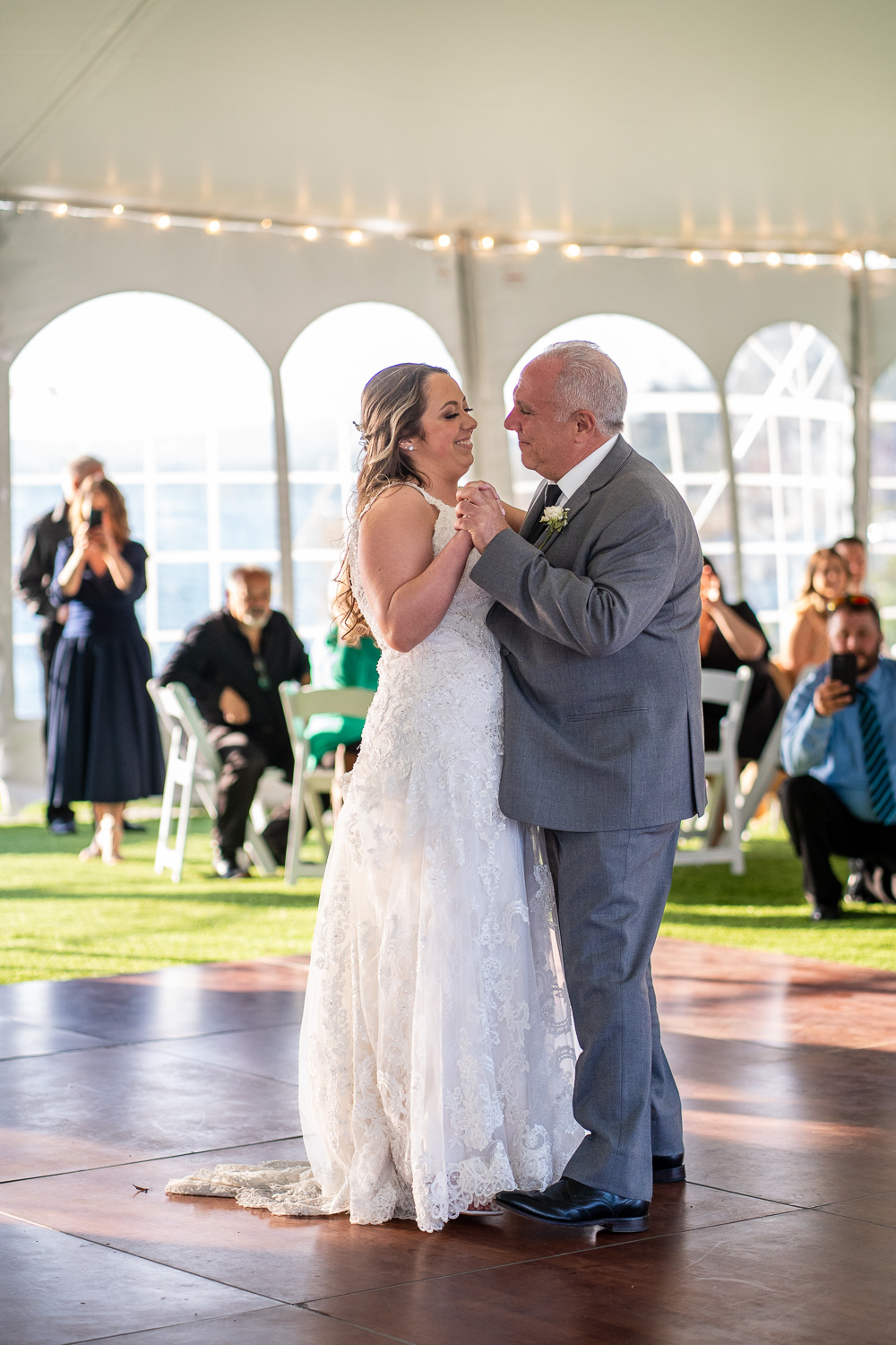 Father of the bride and bride dance at the lakeside wedding 
