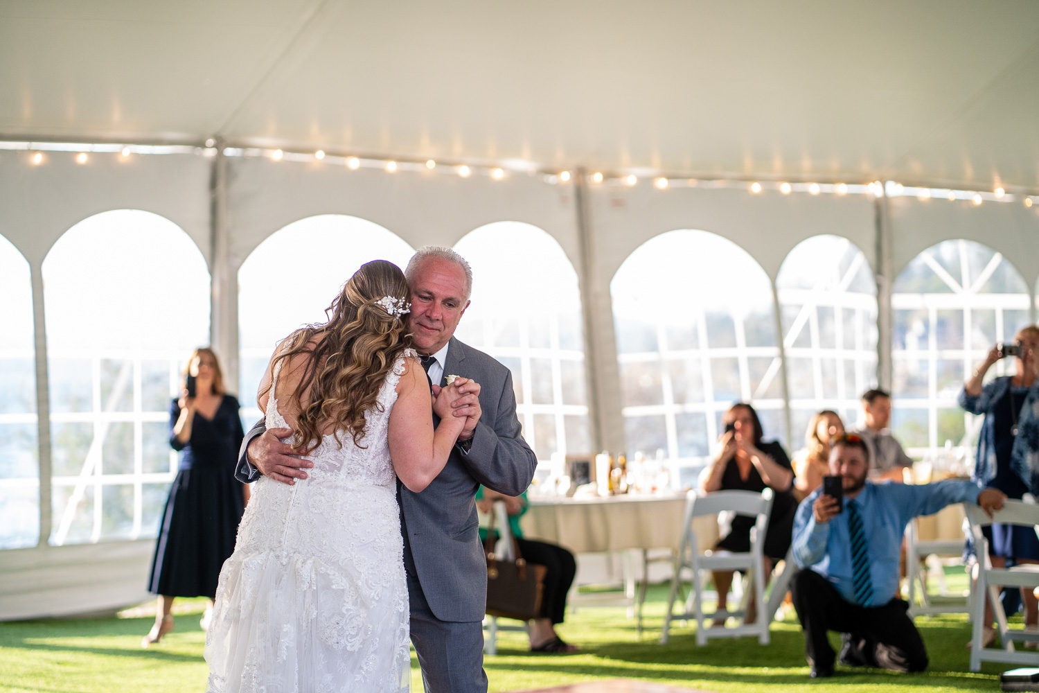 Father of the bride and bride dance at the lakeside wedding