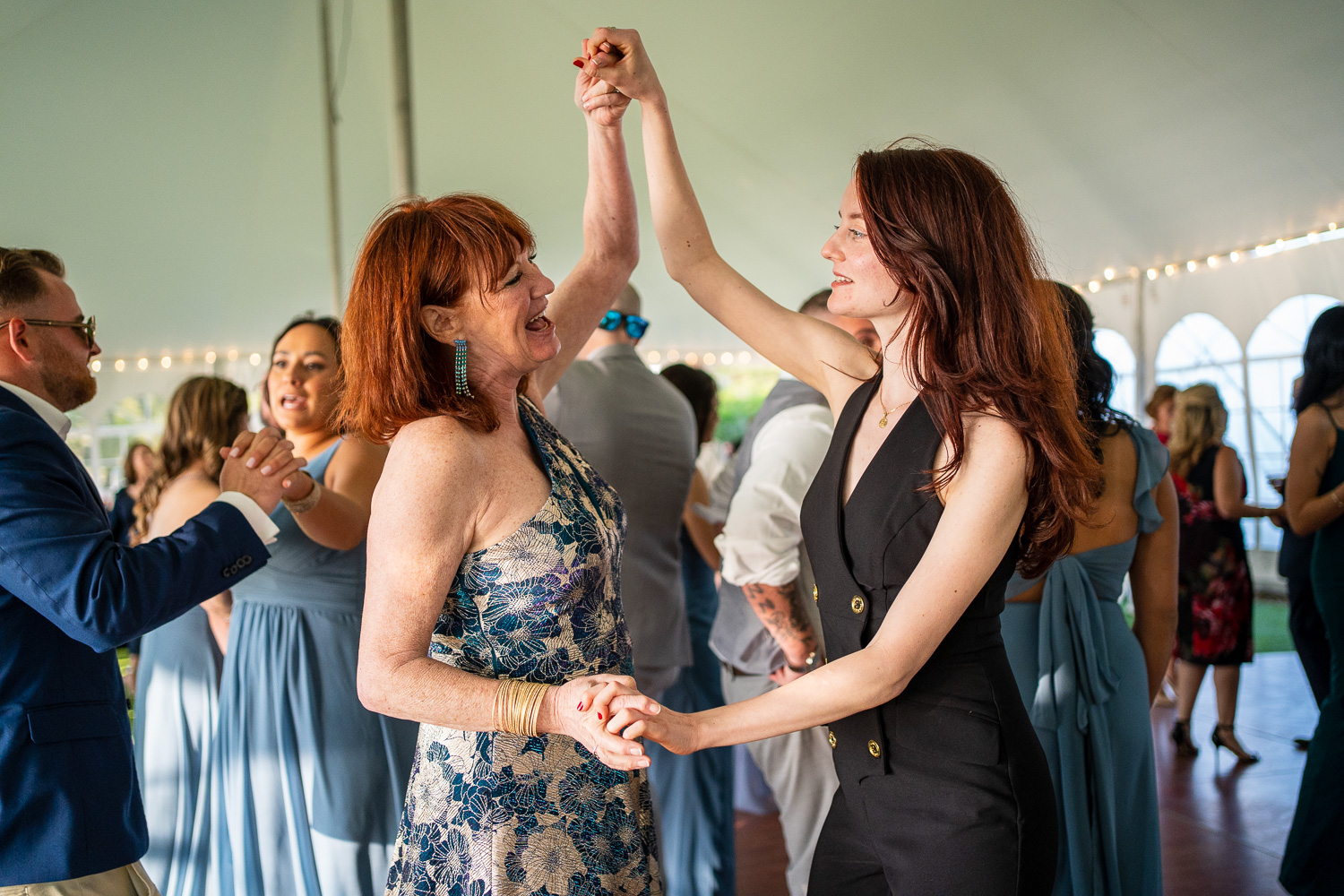 Grooms' mom and sister dancing at the lakeside wedding