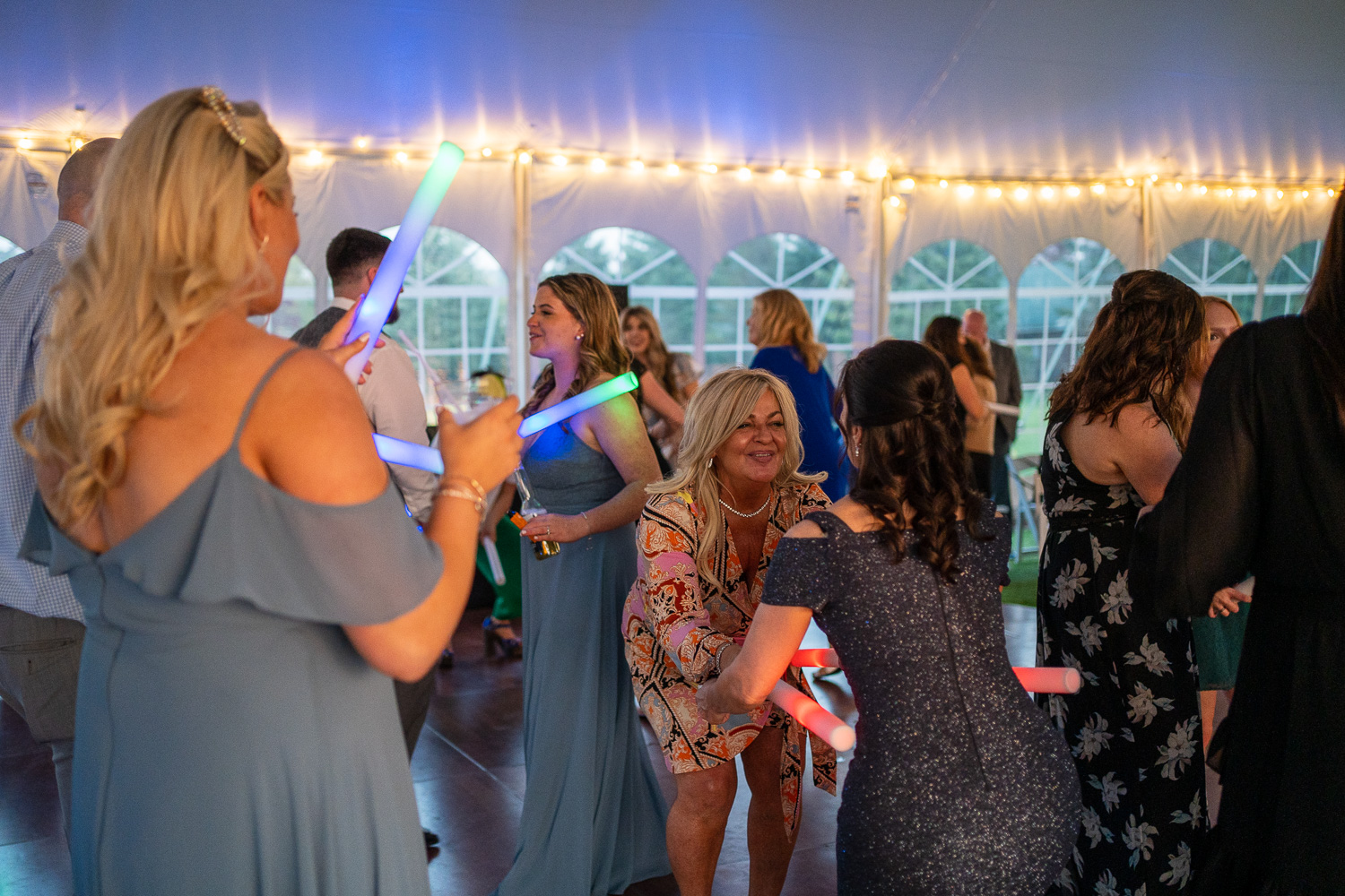 Glow sticks and Dancing at the reception of the lakeside wedding