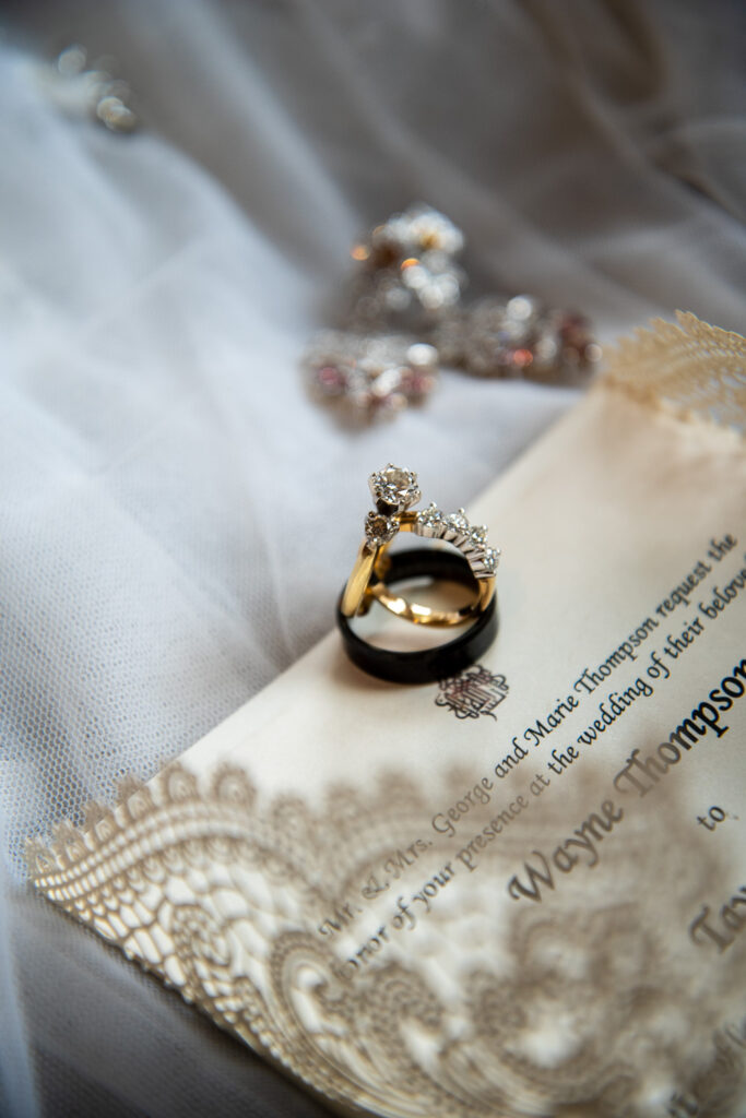 close up of the bridal rings on an invitation