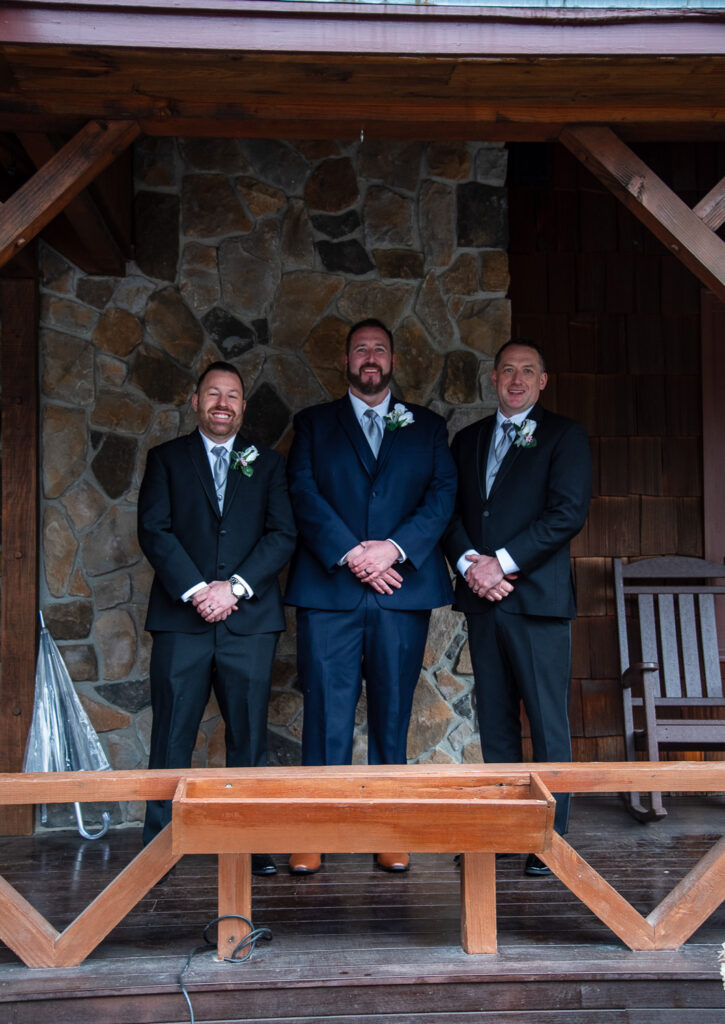 groom and his groomsmen on the front porch of Steele Hill Resort the perfect spot for a wedding with a view