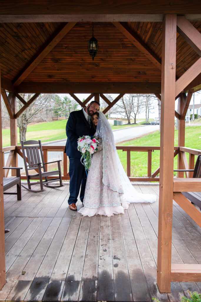 Bride and groom hugging in the gazebo of Steele Hill Resort, the perfect place for a wedding with a view