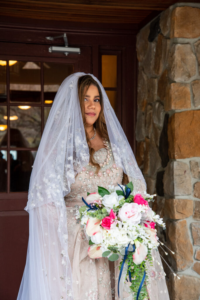bride on the front porch of Steele Hill Resort, the perfect place for a wedding with a view 