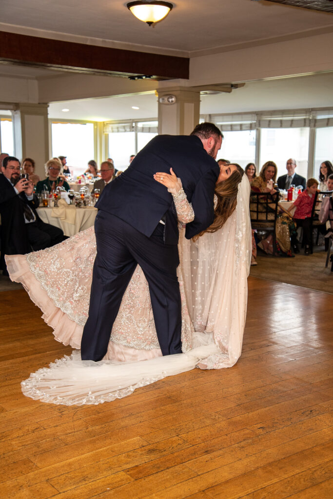 bride and groom sharing their first dance as husband and wife at their wedding with a view