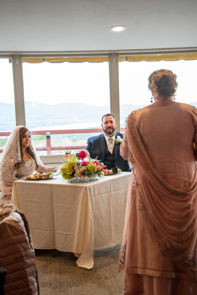 maid of honor giving her speech to the bride and groom at their wedding with a view 
